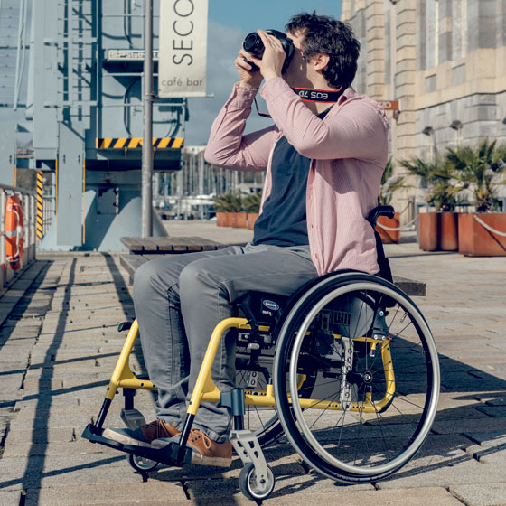 man in a wheelchair taking a photograph