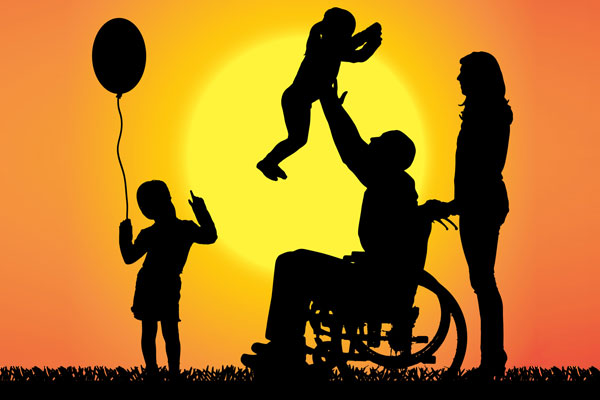 Man in wheelchair holding up child